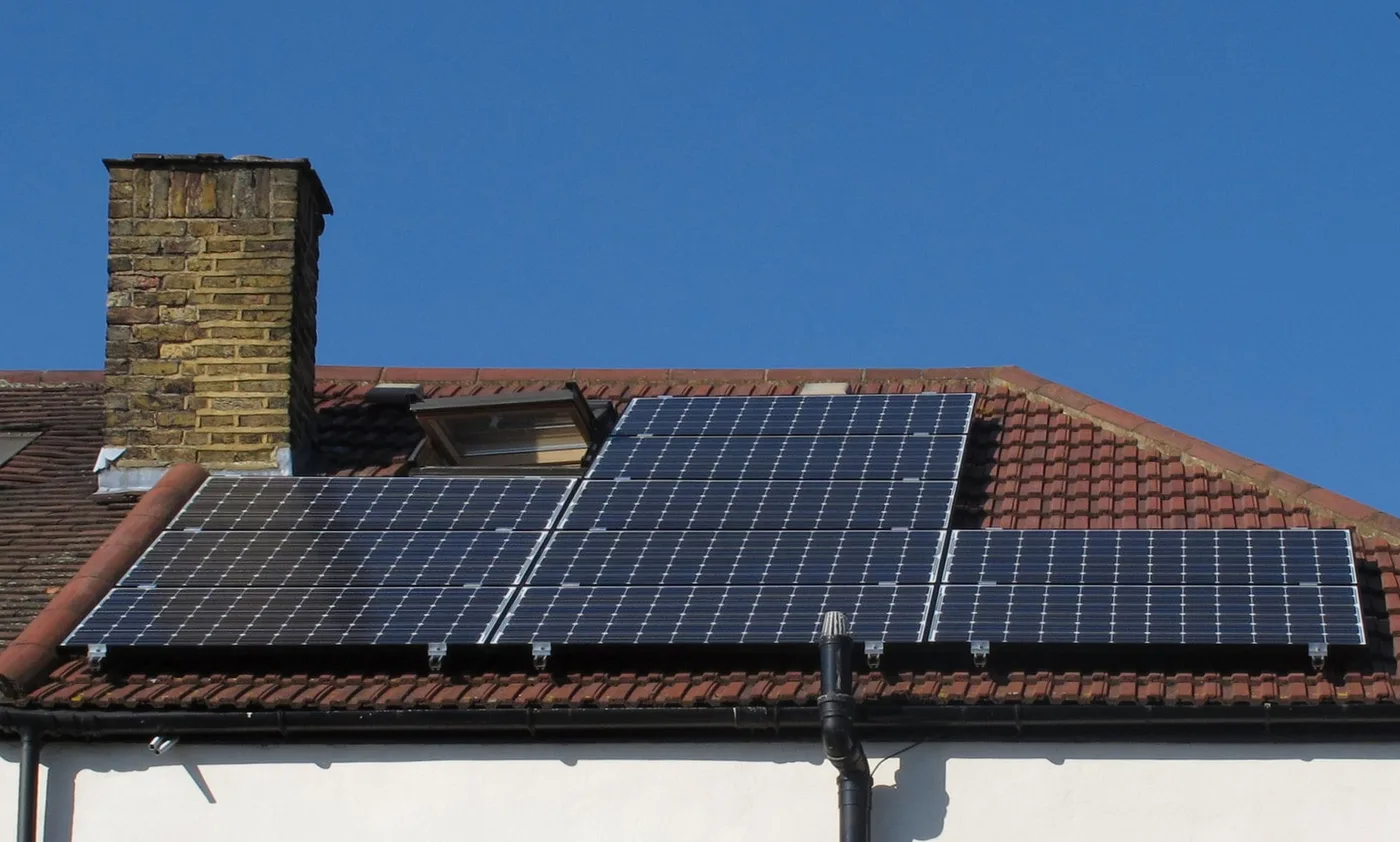 Solar panels mounted on a residential tiled roof with a visible gap underneath